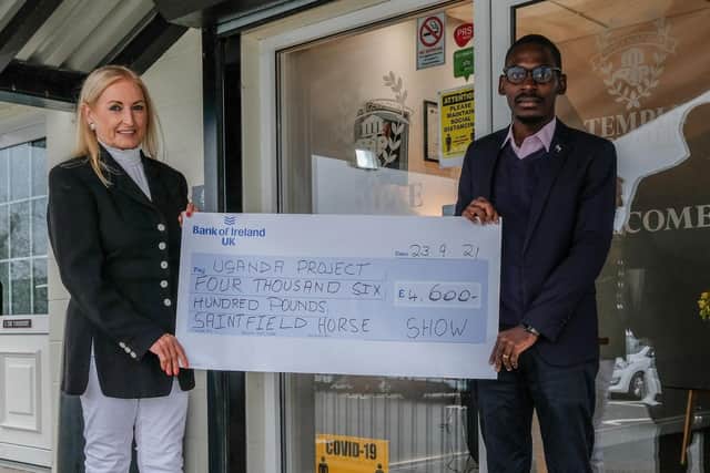 Saintfield Horse Show director Joan Cunningham and Pius Kulama at the Temple Golf Club last Thursday evening with the presentation cheque for £4,600 which will go towards The Ugandan Project