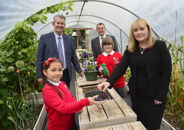 Ballycraigy Primary School P6 pupils Bethany (left) and Elizabeth show Environment Minister Edwin Poots (left), Keep Northern Ireland Beautiful Chief Executive Dr Ian Humphreys and Education Minister Michelle McIlveen the work they do in their garden as part of their Eco School Programme which is funded by DAERA and delivered by KNIB.
