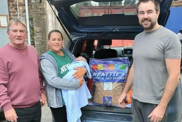 S Milligan & Daughter Jennifer with baby Oisin receiving their bags of BEATTIE's Bird & Pet Foods for Finishing 1st IHU North Pigeon home in the I.N.F.C. Sennen Cove 2021. Well done, keep up the good work. Pictured Sean Milligan, Jennifer with baby Oisin & Jeffrey Beattie.
