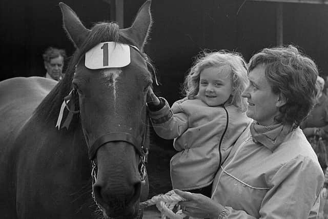 Four-year-old Emma and her mother, Mrs Betty Abraham from Ballinamallard, Co Fermanagh, had a friendly pat for Don the champion brood mare owned by Mrs Madeline Graham of Dublin Road, Omagh, at the Enniskillen (Fermanagh) Show in August 1982. Picture: Farming Life/News Letter archives