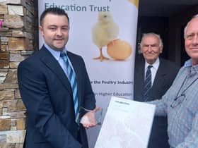 Peter Morgan, Chairman of the Poultry Industry Education Trust, presents the annual Poultry Industry Education Trust  award, a Times Atlas of the World and inscribed memento to Wilson McLeister from Portglenone. Looking on is Basil Bayne, a Fellow of Harper Adams University and PIET Trustee.