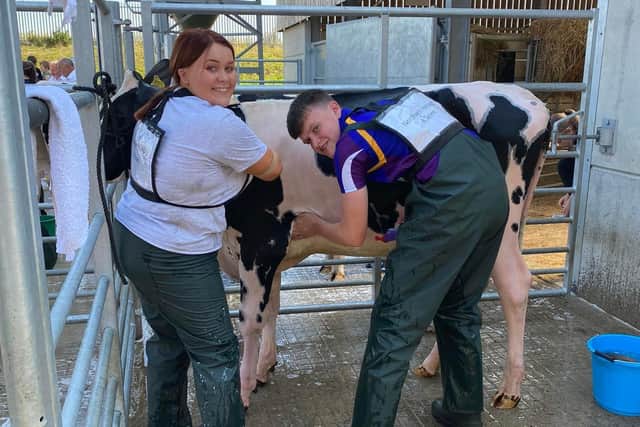 Leah Steele, Crumlin and James Patton, Carrowdore get stuck in to the A team Washing element of the 'Field-2-Foto' event