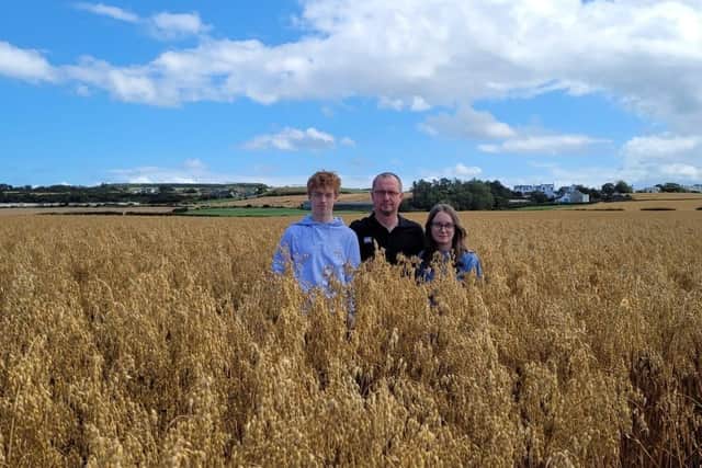Jack, Faye and Richard Dempsey in their field of Oats that was placed first in Northern Ireland.