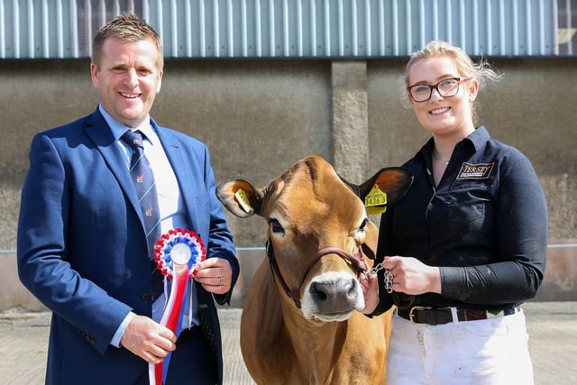 Chloe McNeely from Bready, Strabane, was the champion handler and winner of the mature Jersey showmanship class at the 19th multi-breed dairy calf show. Making the presentation is judge Sam Wake. Picture: Jane Steel