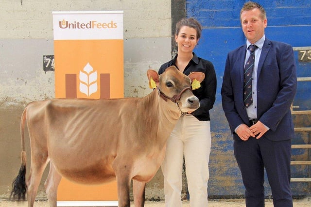 Kristina Fleming, Seaforde, exhibited the reserve champion Jersey, Potterswalls Blackapple Starlight, at the 19th multi-breed dairy calf show. Included is judge Sam Wake. Picture: Julie Hazelton