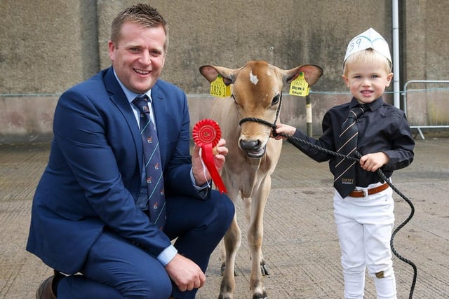 Judge Sam Wake presents first prize to Harris Kennedy who exhibited the May-born calf Potterswalls Dreamer Dawn. Picture: Jane Steel