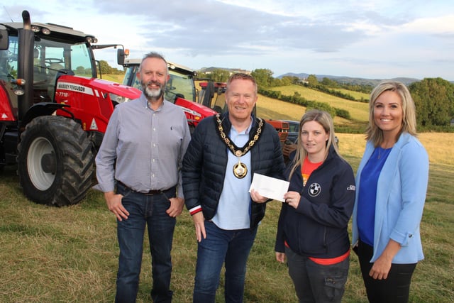 Lord Mayor Alderman Paul Greenfield presents a cheque to Alison Graham, organiser of the tractor run. Councillor Ian Wilson and Diane Forsythe South Down MLA also attended the tractor run at Ardarragh.