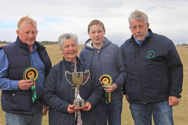 Cathy O'Hara collected the Woodvale Trophy for the best futurity heifer on behalf of Gerard McPeake, Grove Grazer Herd, Garvagh. Included are Robert Moore, Millberry Herd, Armagh, second; and Freddie Davidson, Ember Herd, Banbridge, third. Adding his congratulations is Scottish judge Ian Watson. Picture: Julie Hazelton