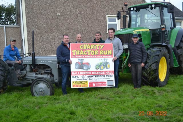 The organising committee of Ballinrees Charity Tractor Run with an example of the tractors expected at their run, from the little grey Fergie to the large John Deere 6930