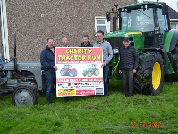 The organising committee of Ballinrees Charity Tractor Run with an example of the tractors expected at their run, from the little grey Fergie to the large John Deere 6930