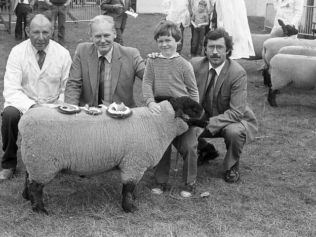 Mr Wilson McCracken from Rasharkin, Ballymena, pictured in August 1982 with his Suffolk ram lamb champion, held by his grandson, Alastair Morrison, at the breed show and sale at Balmoral. Alson in the picture are Mr Brian Smyth, manager of the Ballymena branch of the Bank of Ireland, who presented the sponsorship prizes, and Mr Lowry Cunnigham, agricultural advisor, Bank of Ireland. Picture: Farming Life/News Letter archives