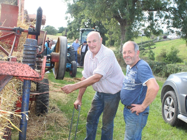 Ernie Mathers and Alan Crory attend to the baler