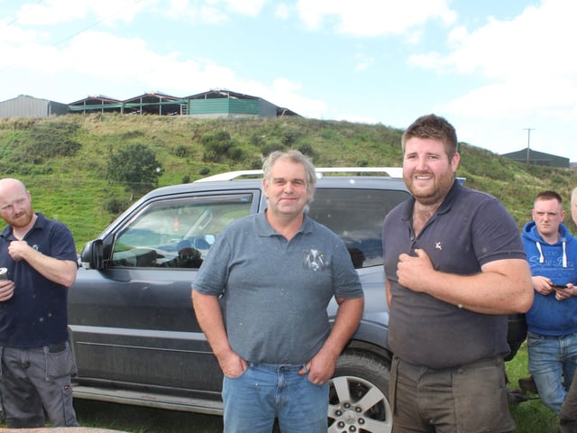 Bobby Fee and Jordan Mathers watch the threshing last Saturday