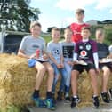 These children enjoyed the threshing on the trailer watched by John Mathers