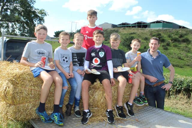 These children enjoyed the threshing on the trailer watched by John Mathers