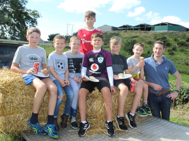 These children enjoyed the threshing on the trailer watched by John Mathers