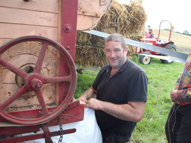 Gordon Mathers keeps an eye on the bags of corn