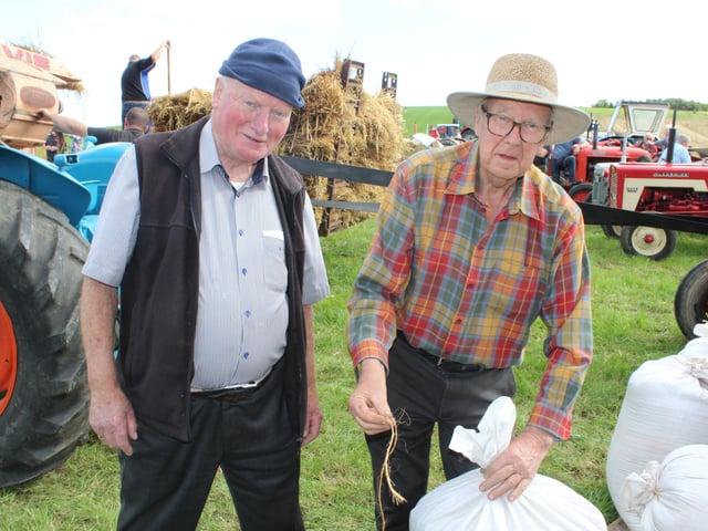 John Hutchinson and Kenny Chambers showing how to tie the bags of corn