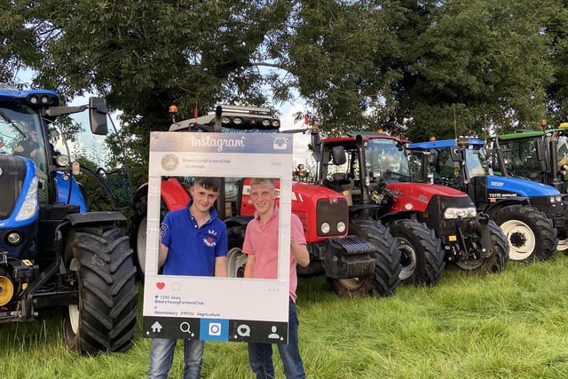 David McAlister and Matthew Nelson standing in front of their tractor