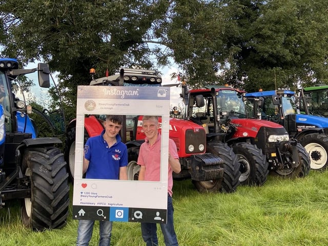 David McAlister and Matthew Nelson standing in front of their tractor