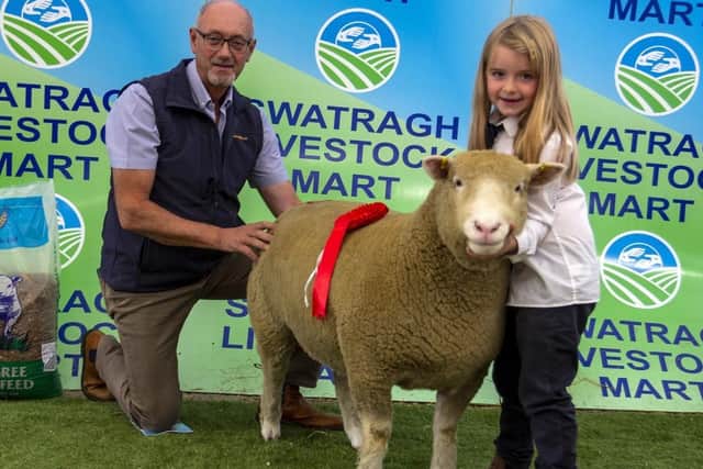 Caroline McKeown with her first prize shearling ewe pictured with sponsor Sam Ritchie (Strabane Mills)