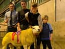 Judge Robert Gamble presents Liam McPolin and sons Bridge Flock with the Fane Valley Championship at the NI Texel Sheep Breederâ€TMs Club Show and Sale in Hilltown