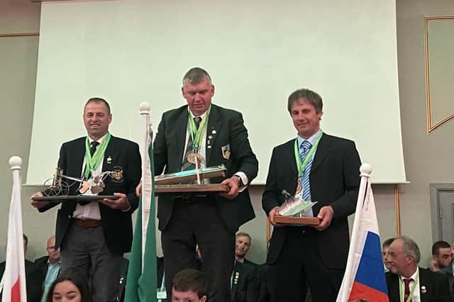 Podium winners from left David Wright, NI second; John Whelan, ROI, first and Igor Pate, Slovenia, third, pictured at the Gala night of the World Ploughing Championships in Ratheniska, Co. Laois