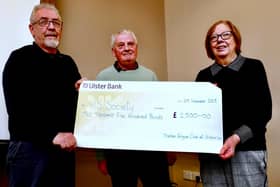 Harry and Jean Gardiner receive the cheque for £2,500 from Trevor Beattie (centre). Pic: Alan Hall