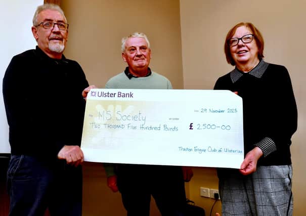 Harry and Jean Gardiner receive the cheque for £2,500 from Trevor Beattie (centre). Pic: Alan Hall