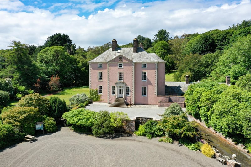 Queen Anne house with three reception rooms, nine bedrooms, nine bathrooms and woodland gardens