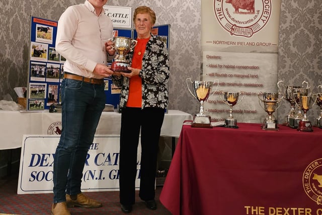 Matthew Bloomer accepts the Carnbrooke Cup from Deirdre Hilton for Best Senior Bull at RUAS Balmoral Show 2023.