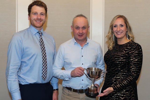John Hamilton receives an HYB trophy on behalf of his son David Hamilton. Included are Holstein NI chairman Jonny Lyons and wife Cheryl. Picture: Kevin McAuley 