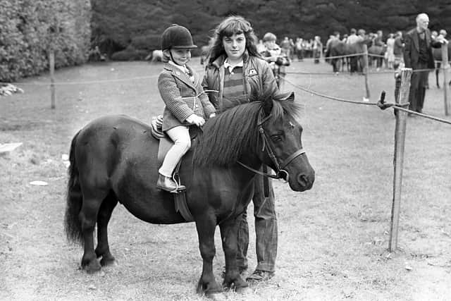 Three-year-old Julia Murdoch from Castle Farm, Comber, on her pony Squirel of Netherby with Ingrid Casey of Lisbane, Comber, at the Antrim Show in July 1980. Picture: News Letter archives/Darryl Armitage