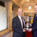 BT cup winner Dr Sam Strain being presented with the trophy by UFU president David Brown. Pic: McAuley Multimedia