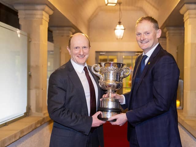 BT cup winner Dr Sam Strain being presented with the trophy by UFU president David Brown. Pic: McAuley Multimedia