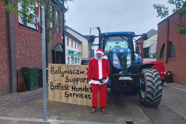 Members of Ballymiscaw YFC meet with Santa Claus during their tractor run, the run raised £400