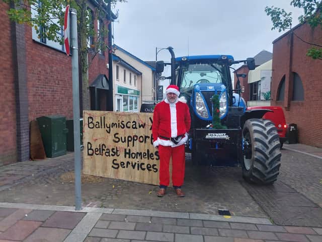 Members of Ballymiscaw YFC meet with Santa Claus during their tractor run, the run raised £400