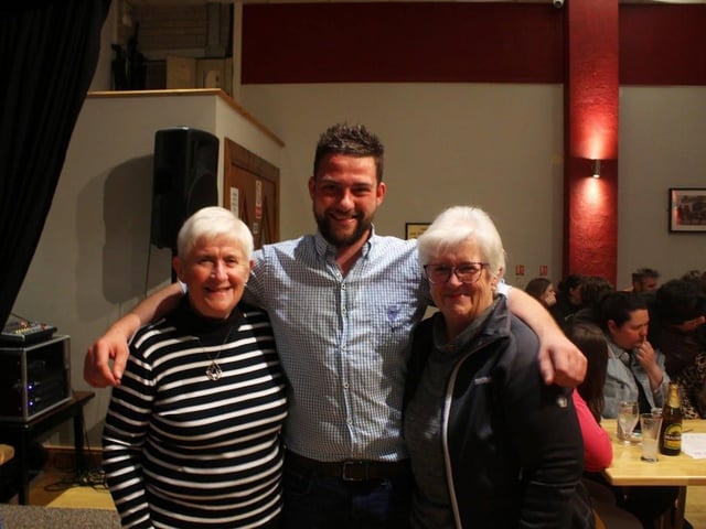 Outgoing club leader with quiz hosts