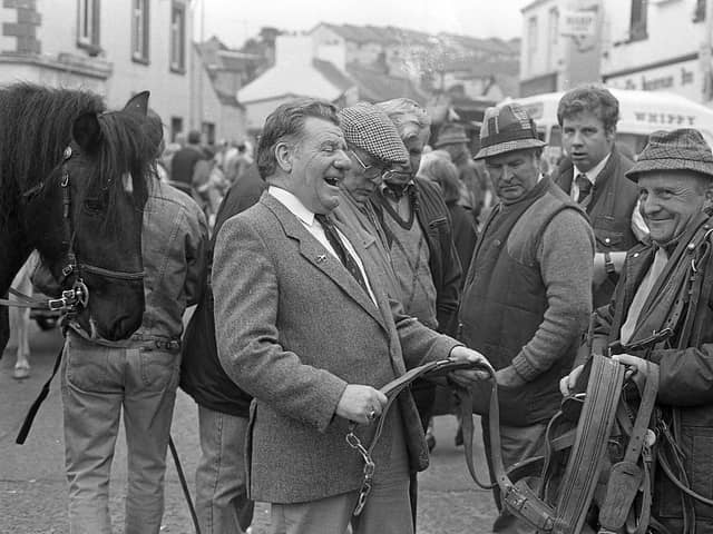Pictured at the end of September 1992 at the Dromore Horse Fair is ‘Julie’ Hunter from Carryduff who is seen here enjoying a lighter moment at the fair with an interested observer over his shoulder. Picture: News Letter archives/Darryl Armitage
