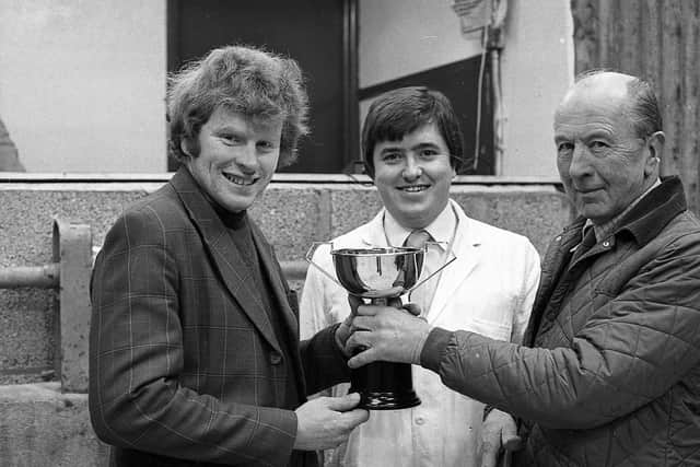 Pictured in January 1983 is John Watt of Watt and McBriar Ltd, Saintfield, presenting the championship cup to William Fay of Portaferry at the Allams show and sale of quality calves which was held in Newtownards. In the centre is auctioneer, Robert McKeown. Picture: Farming Life/News Letter archives