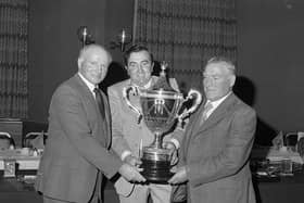 Brian King (centre) gives a hand with the handsome trophy presented to Reggie Suffern (left), Crumlin and Jack Liggett, Tandragee during Ulster Ayrshire Club’s annual dinner and prize distribution which was held in Ballymena in November 1981. Picture: Farming Life archives/Darryl Armitage