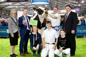 RUAS President Christine Adams, Rodney Brown, Head of Agribusiness at Danske Bank and livestock judge Mike Duckett join the Jones family from Hallow Holsteins as Hallow Solomon Twizzle 3 is crowned the 2023 Supreme Interbreed Champion.