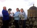 Pictured at the end of June 2002 are Natasha and Zowie Maguire who are seen presenting Willard Smyth, from Downhill Sheepdog Society, with a cup in memory of their late mother, Rosealeen Maguire. The cup was competed for in the novice section at the Downhill trials which were held on Saturday, July 6, 2002. Picture: News Letter archives/Kevin McAuley