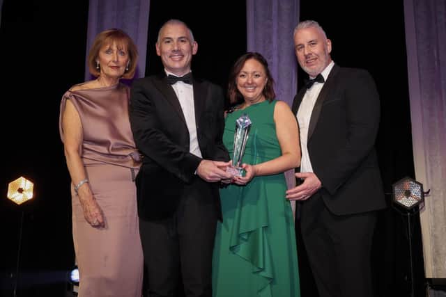 Anne McMullan, director of marketing and communications at Visit Belfast, presents the Tourism and Hospitality Company of the Year award to Lough Erne Resort’s Jonathan Gallagher, director of marketing; Lydia Woods, sales and events manager; and Barry McCauley, director of Golf at the AIB BusinessEye Awards.