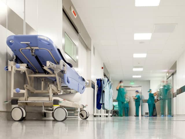 Blurred figures of people with medical uniforms in hospital corridor