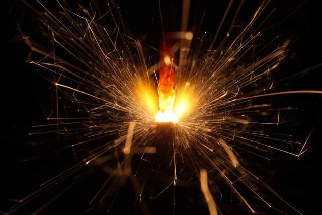 Macro photo of firework sparkler with black background.