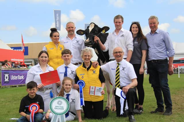 The Millar family from Coleraine with their Holstein and interbreed dairy champion Damm Tatoo Sallie, bred by the Simpson family, also pictured right. Picture: Julie Hazelton