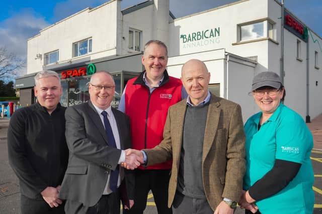 David Miskimmin (front left) from Henderson Retail is pictured with former SPAR Barbican, Annalong owner Simon Heenan (front right) and store staff (back, from left) Mark Clerkin, Derek McCallen and Linda Gordon. Pic: Aaron McCracken