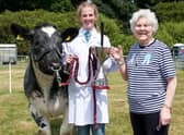 Grace Elwood and her British Blue Heifer wining the Cecil and Molly Robinson Perpetual Cup for best young handler in the beef section at this year’s Castlewellan Show, presented by show vice president Molly Robinson.