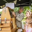 A family viewing bees in a special glass-fronted hive at last year's Hillsborough Honey Fair.